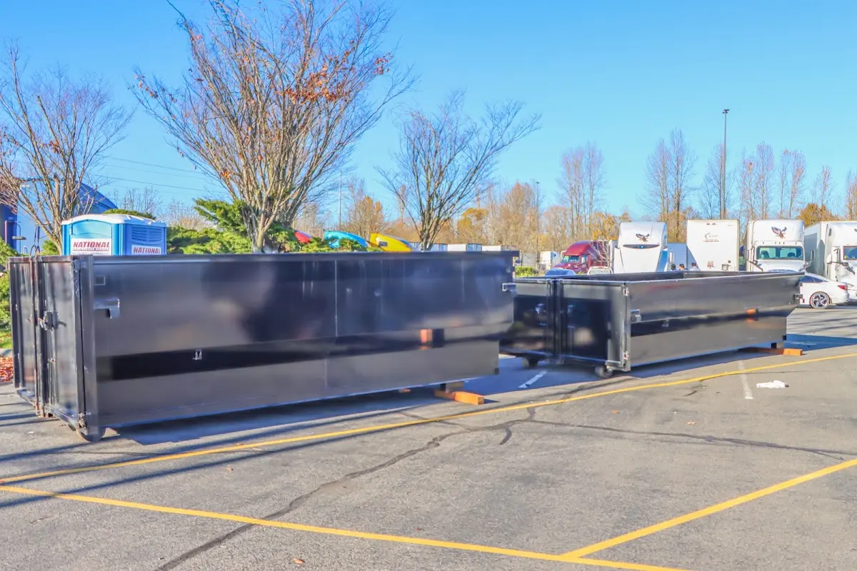 Professional dumpster rental service with roll-off container on residential driveway in Wapakoneta